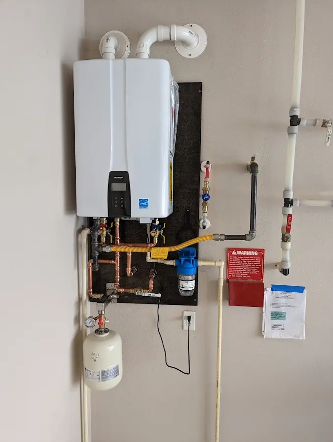 Professional plumber installing copper piping in a Sumpter home